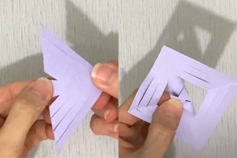 Mở tờ giấy đã cắt, cuốn cạnh của hình vuông nhỏ bên trong.