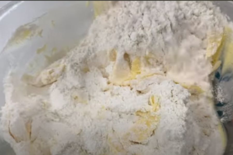 Cho bột vào hỗn hợp bơ và tiếp tục trộn đều.