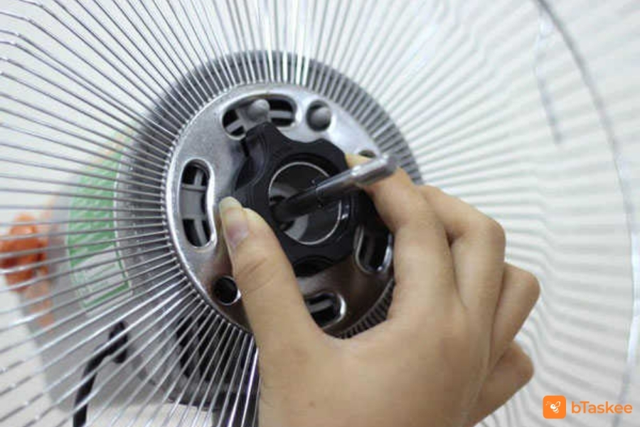 Xoay chốt và tháo khung lồng sau.